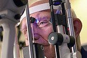 Senior man having an eye check up