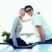 Couple in convertible wearing sunglasses